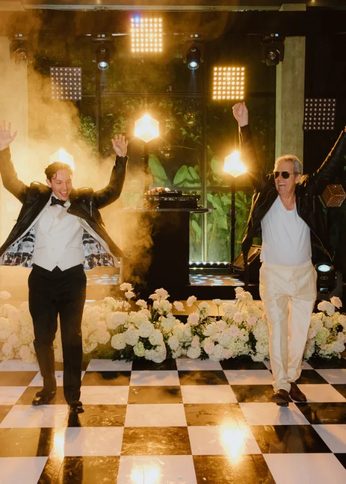 Groom and father dancing at a luxury wedding reception.