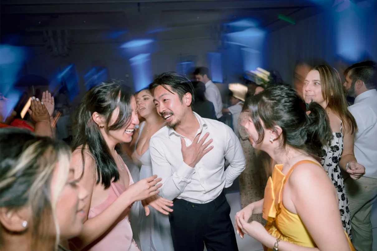 Guests laughing on dance floor at wedding perfomed by DJ CERON.